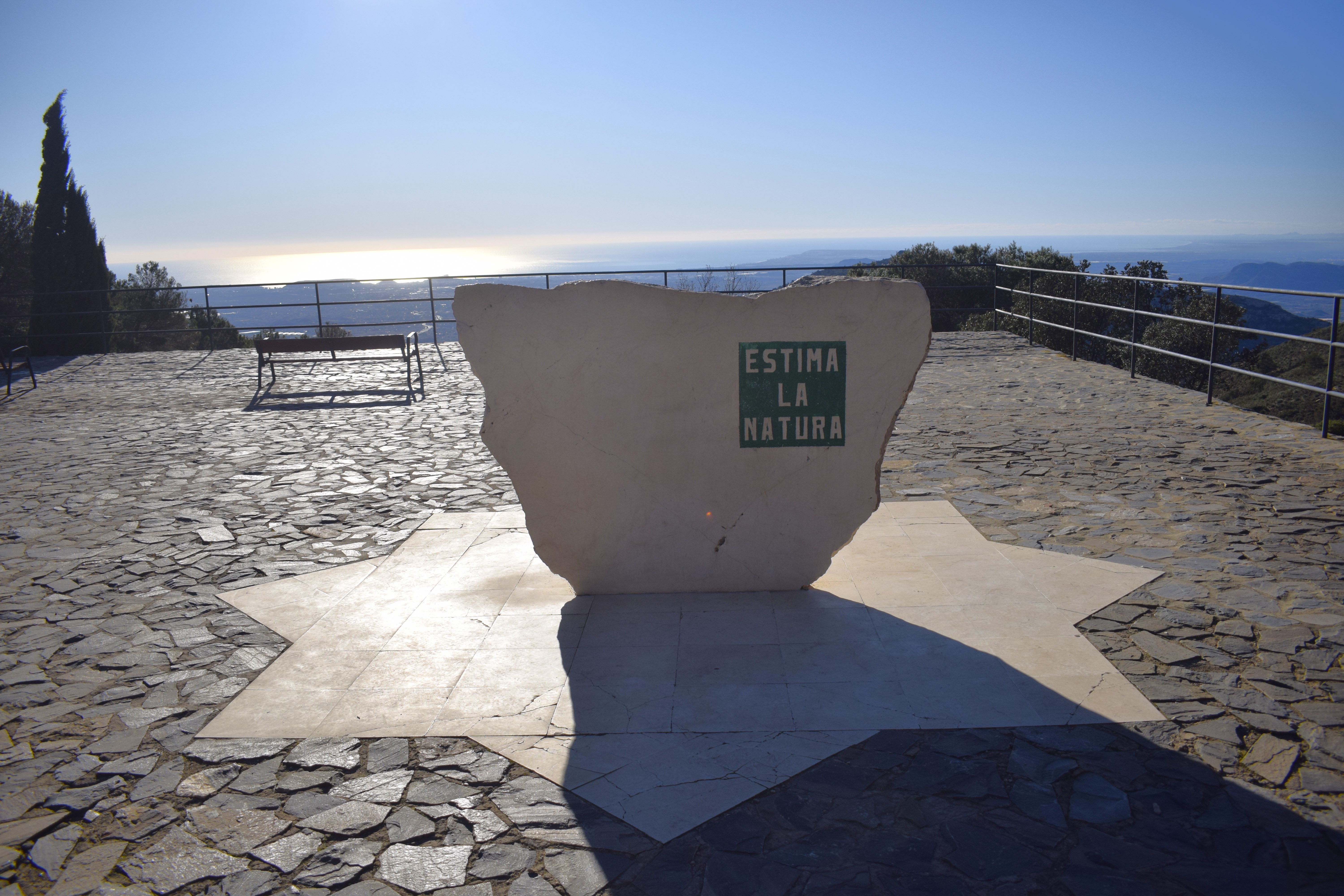 A monument saying 'Estima la natura'; Catalan for 'Love nature'.