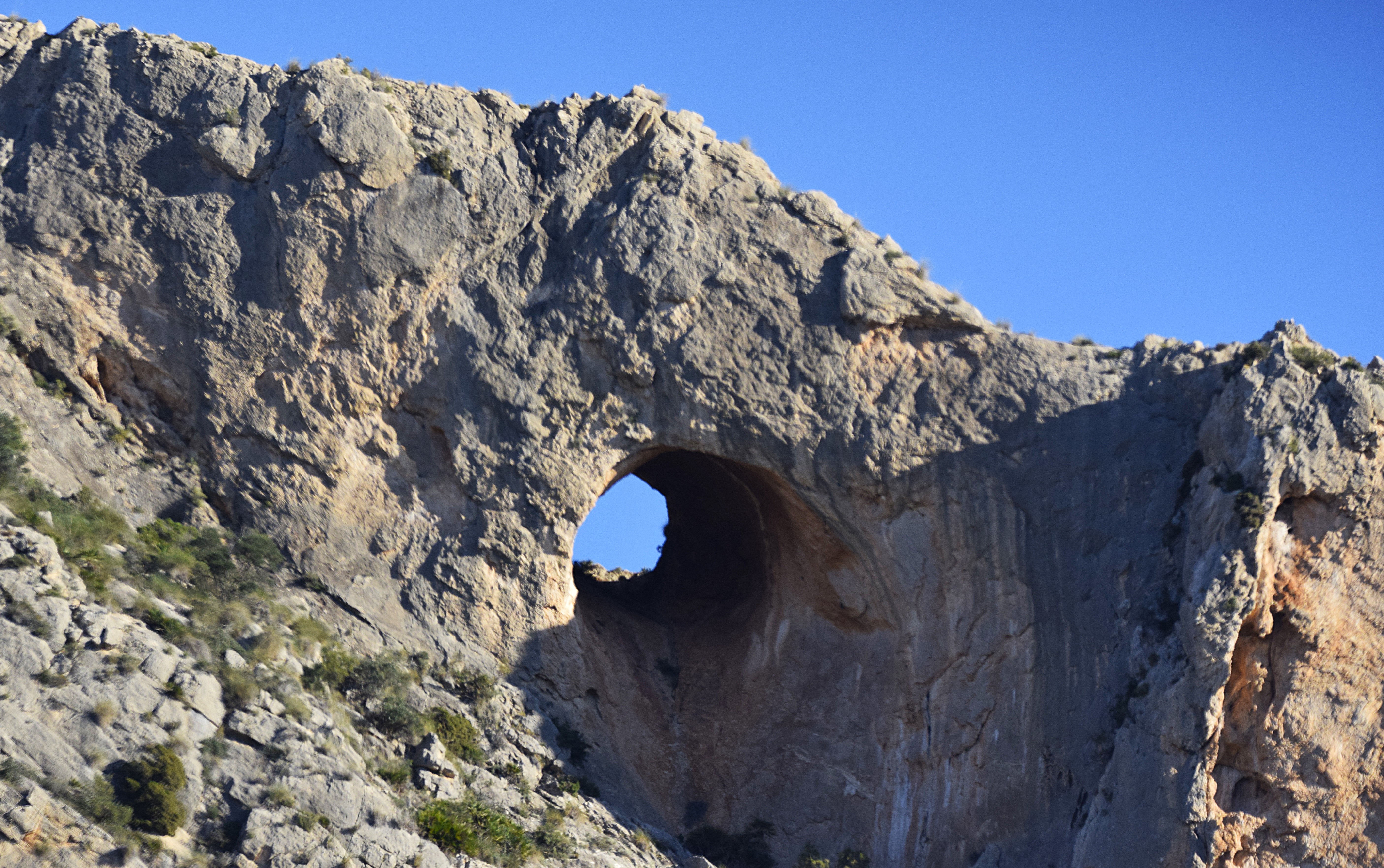'El Pet de la Reina', a strange rock arch in the Cabeçó d'Or mountain range.